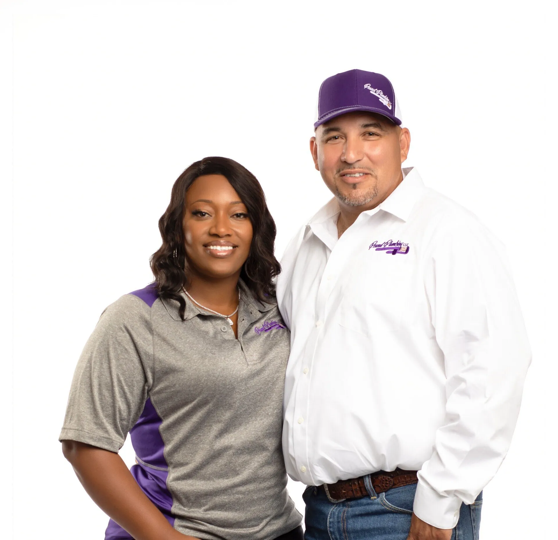Peanut Plumbing team portrait of two staff members in branded uniforms.